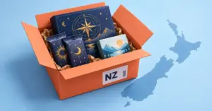 An open parcel labelled NZ contains fantasy trading card packs, a board game and a puzzle beside a silhouette of New Zealand.