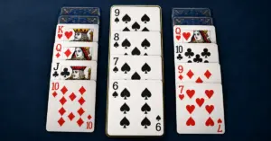 Three overlapping card columns on a navy surface, with a gold outline highlighting a descending sequence from nine to six of spades in Russian Solitaire.